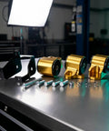 Tough As Nails Aluminum Alloy Engine Mount Bracket With Precision Cut Bolt On Hardware For Rock Solid Stability And Zero Engine Shake Grease Monkey Approved For Weekend Builds assembled with black and gold components and bolts on a workbench.