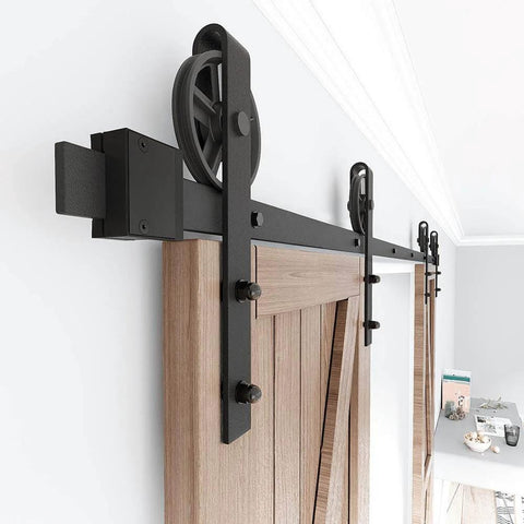 Black Wood Double Sliding Barn Door Hardware Kit With Big Spoke Wheel Rollers installed on wooden door frame