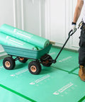 Person transporting rolls of Pro Grade Heavy Duty Temporary Floor Protection Film For Construction And Renovation 39 Inch By 100 Foot Green Surface Shield on cart