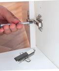 Hand holding screwdriver to install Premium Heavy Duty Soft Close Cabinet Damper For Kitchen Wardrobe Doors.