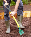 D Grip Shovel Handle Replacement With 32mm Inner Diameter Metal Core And Wooden Grip in use in a garden setting