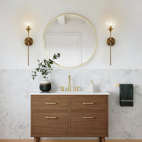 Glass Globe Wall Sconce In Brushed Brass With Clear Globe Mid Century Modern Bedroom Bedside Lighting Long Pole Nordic Style Wall Lamp For Living Room And Bathroom Decor And Accent Lighting Dope Vibe installed in a bathroom with a large round mirror.