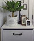 White cabinet with 8 Piece Black Barn Door Handles For Wooden Fences And Cabinets, potted plant, and decorative items on top