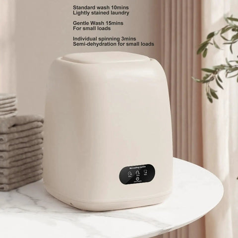 Game Changing 9L Portable Washing Machine With Spin Dryer And Clever Hidden Drain Hose on a marble table, compact and modern design.