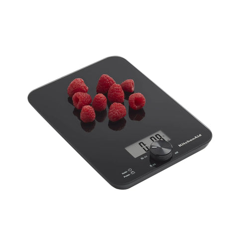 Digital Glass Top Kitchen Scale With 11 Lb Capacity displaying raspberries, rotating knob, black surface, precise for baking.