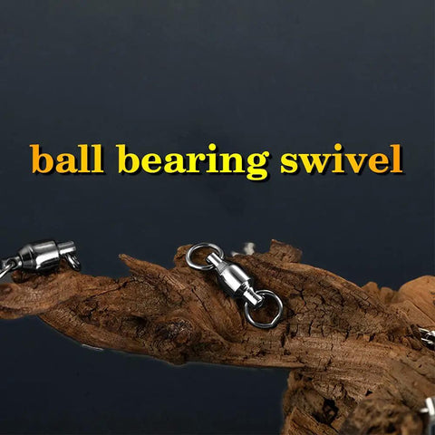 Saltwater Rolling Barrel Ball Bearing Swivels With Stainless Steel Construction High Strength Solid Welded Rings Black Nickel Finish 25 Pack 110 Lb Capacity For Serious Fishing, shown on wood