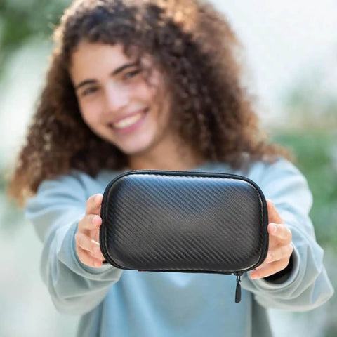 Dope Black Carbon Pencil Case With Hella Spacious Tech Stash And Badass Anti Scratch Shell Designed For School Gear, held by a smiling girl.