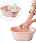 Collapsible Pink Wash Basin Set Of 2 Foldable Portable Laundry Basins holding toiletries next to hands washing, space saving design