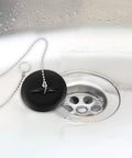 2 Pcs Black Silicone Bathtub Drain Stopper with Chain for Shower Use, close-up view of black stopper over a drain.
