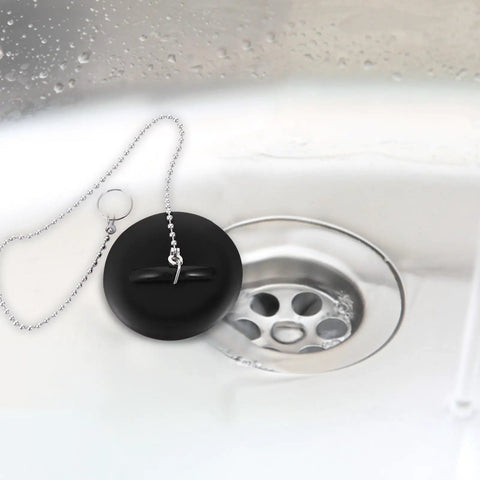 2 Pcs Black Silicone Bathtub Drain Stopper with Chain for Shower Use, close-up view of black stopper over a drain.