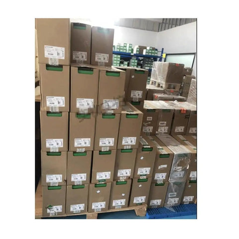 Boxes of ATV610D37N4 PLC Module 380V 37KW Industrial Controller With One Year Warranty stacked in a warehouse