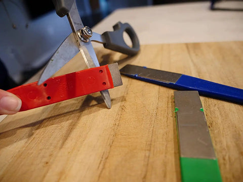 DiaSharp Diamond Mini Hone Sharpening Kit used on scissors, includes red, blue, green 2.5-inch grit stones for edge restoration.