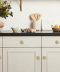 2 Pack 2.5 Inch Brushed Brass Cabinet Knobs With Vintage Backplates installed on kitchen cabinets