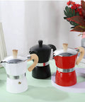 Three moka pots in white, black, and red with wood-grain handles, suitable for Turkish coffee lovers, outdoor use, around 300ml each.