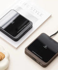 20W Adjustable Mug Warmer in matte black and wood finish on a desk, keeping beverages hot while working.