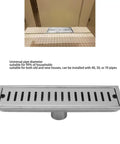 Close-up of Oreilet Linear Shower Drain 12 Inch Floor Drain with Hair Catcher, stainless steel, installed in bathroom floor.