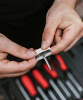 Close-up of hands holding Anti Slip Furniture Pads With Nail On Glide for chairs and tables, rubber and steel construction, 40 pieces