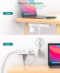 Ultra Slim Flat Plug Power Strip With Twelve Outlets And Three Sided Access Smooth Operator Five Foot Extension Cord attached under table and against wall.