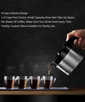 Pouring coffee from a portable espresso machine into four cups, showing compact design for efficient home or office use.