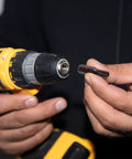Heavy Duty T20 Torx Screwdriver Bits With Rock Solid Magnetic Security Heads And Snug 1/4 Inch Hex Shank Made From Top Shelf S2 Steel For A Dang Strong Hold On Every Fastener In This Sweet 24 Piece Bit Set held by a person with a drill.