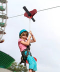Child enjoying Easy Backyard Zip Line Kit For Kids And Grownups, 160 Ft Of Thrill, Supports Up To 330 Lbs with trolley and seat.