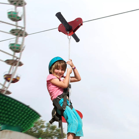 Child enjoying Easy Backyard Zip Line Kit For Kids And Grownups, 160 Ft Of Thrill, Supports Up To 330 Lbs with trolley and seat.