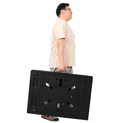 Man carrying Portable Folding Workbench With 1650 Lbs Capacity Heavy Duty Work Table For Garage Shop Or Home Setup In A Snap And Easy Fold