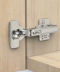 Chibery satin-nickel concealed cabinet hinge, clip-on, soft-close, installed on light wood cabinet door