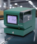 Heavy Duty Digital Time Recorder Featuring Solid Steel Construction And Bright Backlit Lcd Display Designed For The Daily Grind And Rugged Work Floors close-up view on work surface.