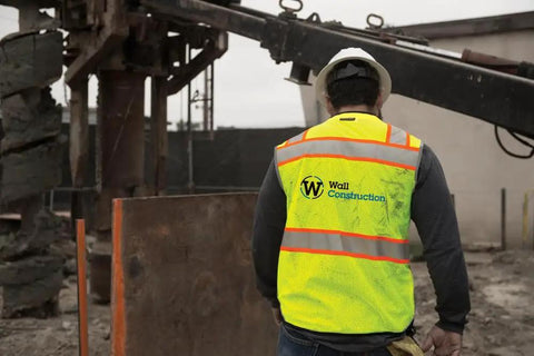 Mens High Visibility Reflective Safety Vest Premium Black Bottom Zipper Ansi Class 2 Construction Utility Workwear Lime Green Large worn at construction site.