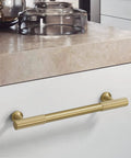Brushed Gold Modern Kitchen Cabinet Handles Set 5 Pack Solid Brass Drawer Pulls installed on a white kitchen cabinet drawer.