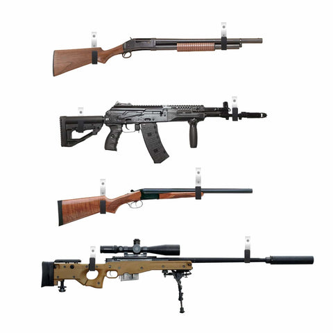 Various rifles mounted on wall hooks for storage display with wood and metal finishes.