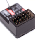 Close-up of FGr4P 2.4GHz AFHDS 3 Four Channel RC Receiver With PWM PPM I Bus S Bus Output showing receiver pins.