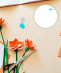 20 Pack Long Needle Threaders Set For Embroidery Cross Stitch Quilting And DIY Crafts Stainless Steel Stable Construction Quick Threading Tool For Yarn Wool Knitting Needles And More, shown with paper flowers