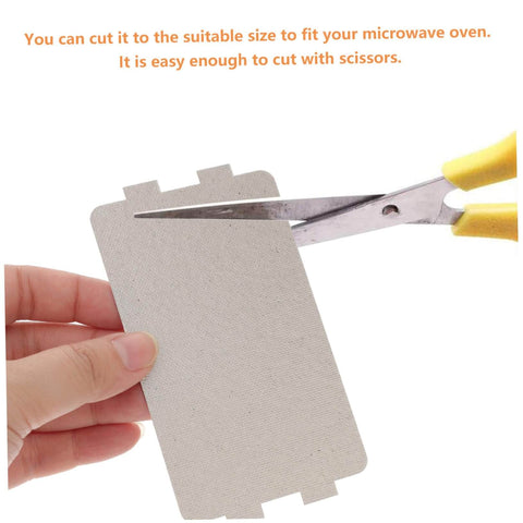 Person cutting Microwave Waveguide Mica Sheets 12 Pack Heat Resistant Insulation Pads And Replacement Plate for Cooking And Baking.
