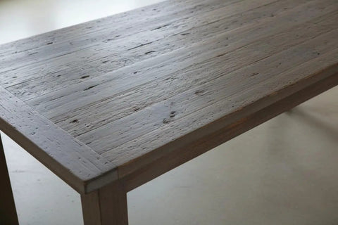 Close-up of a wooden table surface with a light beachwood finish, showcasing the texture of Kickback Beachwood Water Based Wood Stain For Interior And Exterior Use That Brings A Laid Back Coastal Flair To Your Deck With No Voc Drama And A Natural Sun Washed Look Perfect For Weekend Crews And DIY Enthusiasts.