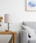 Modern Wood Bedside Lamp With Linen Fabric Shade And Sturdy Base on table beside sofa, cozy living room decor, 16 inch tall.