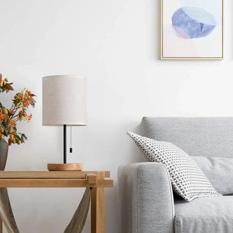 Modern Wood Bedside Lamp With Linen Fabric Shade And Sturdy Base on table beside sofa, cozy living room decor, 16 inch tall.