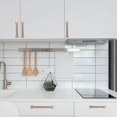 Modern kitchen with Champagne Bronze Cabinet Handles Set of 10, 5 Inch (128mm) Drawer Pulls installed on white cabinets.