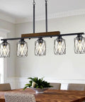 The Real Deal Five Light Farmhouse Chandelier With Slick Vintage Iron Frame And Crisp Clear Shades Giving Off Clean Modern Industrial Lighting Vibe For Dining Room Table Centerpiece, featuring five glass shades and black iron frame.