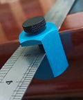 Close-up of Heavy Duty Aluminum Framing Square Jig Quick Set Rafter Layout Guide attachment on ruler for precision woodworking.