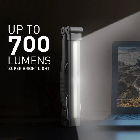 Portable LED Work Light With 700 Lumens COB, Foldable And Rechargeable 3200mAh Battery, standing beside a laptop, casting light