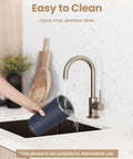 Person cleaning the dark blue 4 In 1 Milk Frother And Steamer For Latte And Cappuccino At Home under a kitchen sink tap.