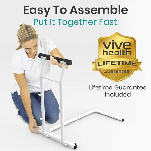 Woman assembling Heavy Duty Toilet Safety Rail With Arms providing top shelf bathroom support in white frame.