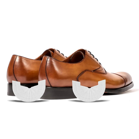 Rubber Shoe Heel Repair Pads 4mm White 1 Pair placed near brown dress shoes, enhancing traction and silence while walking.