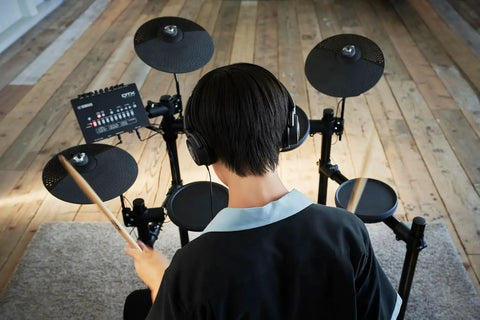 Person playing DTX-PRO Electronic Drum Trigger Module With 70 Premium Customizable Kits in studio setup
