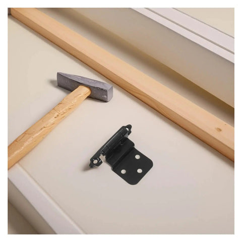 Adjustable Self Closing Hidden Spring Cabinet Door Hinge In Black Finish, shown uninstalled on white surface, with hammer nearby
