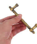Hand holding vintage zinc alloy cabinet pulls and drawer handles two pack solid metal retro heavy duty door hardware 96mm hole spacing