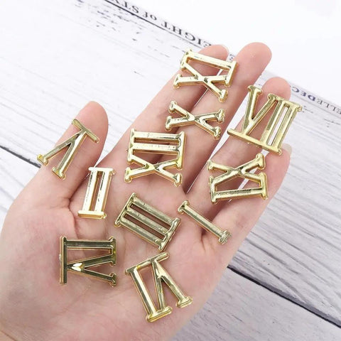 12 Piece Clock Numerals Kit For DIY Repair Arabic And Roman Digits Quartz Wall Clock Parts in hand showing gold numerals