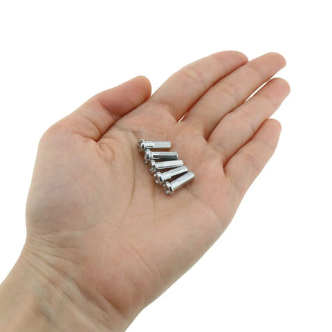 Hand holding 36 Pack 12mm Mountain Bike Spoke Nipples Silver for 14G Wheels, Rust Resistant CNC Anodized Spoke Caps